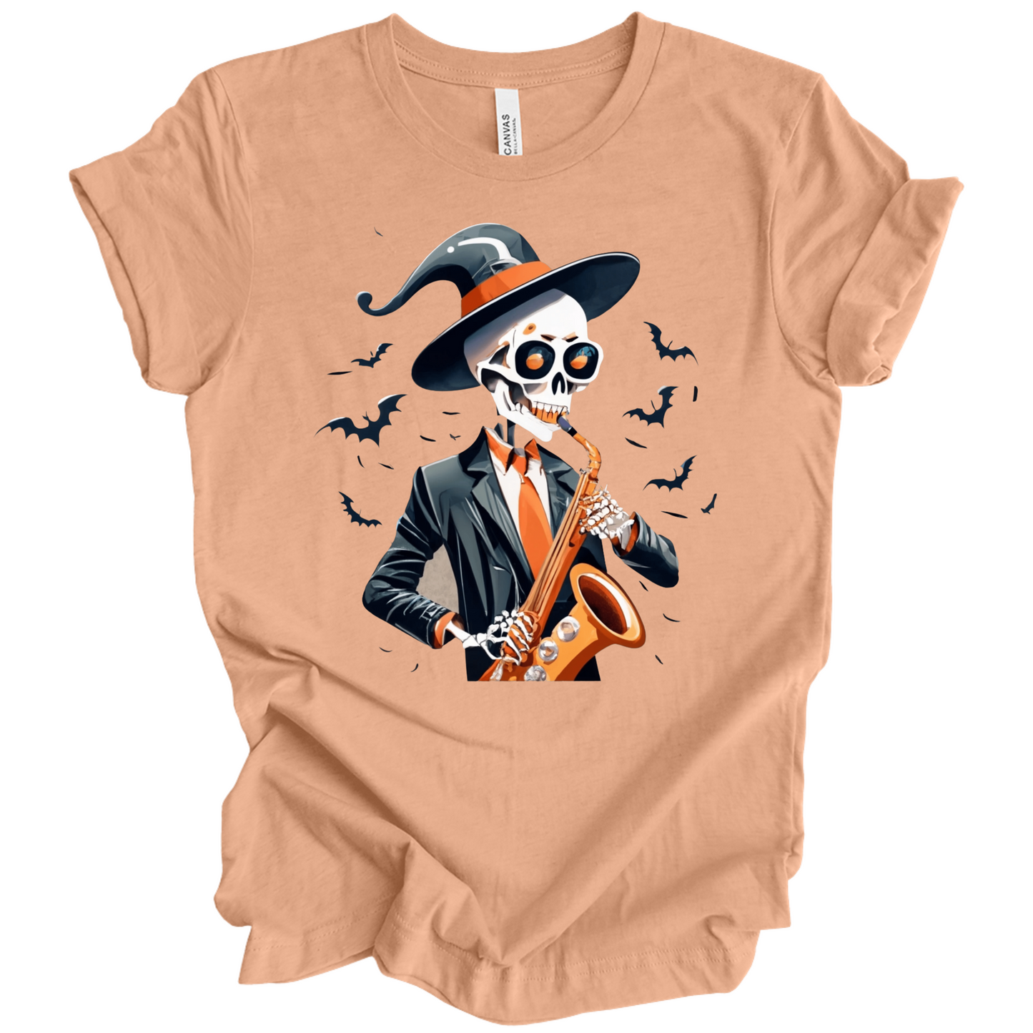 Peach halloween t-shirt with a skeleton playing a saxophone and wearing a witch hat, surrounded by bats.