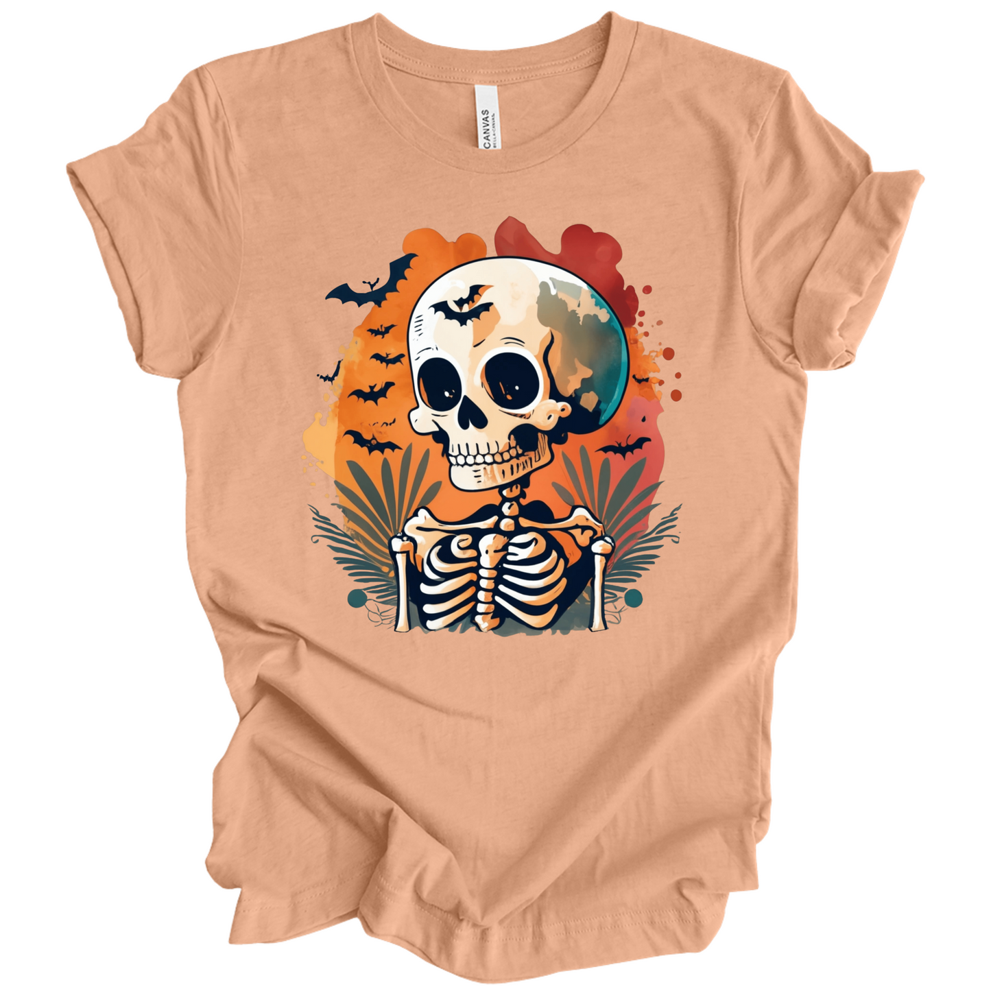 Peach t-shirt with a Halloween-themed design featuring a skeleton and skull surrounded with bats.