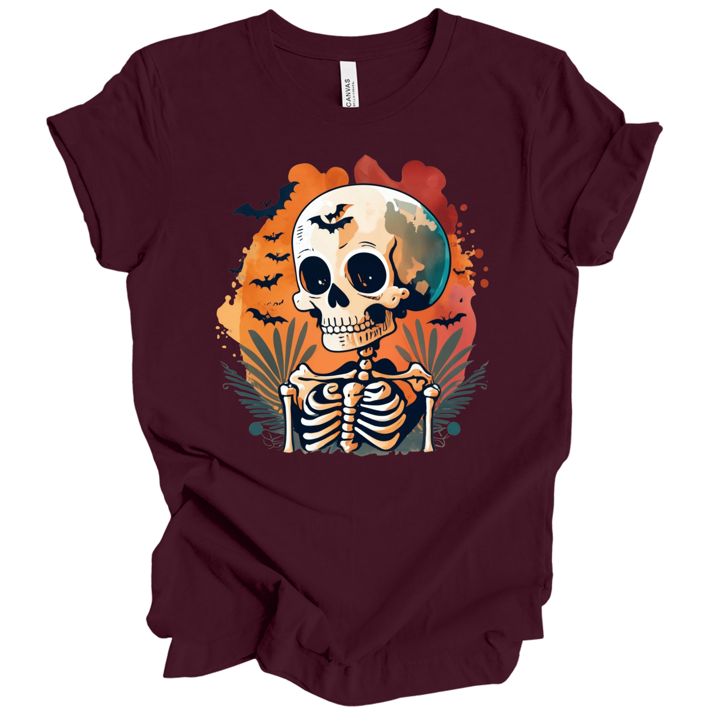 Maroon t-shirt with a Halloween-themed design featuring a skeleton and skull surrounded with bats.