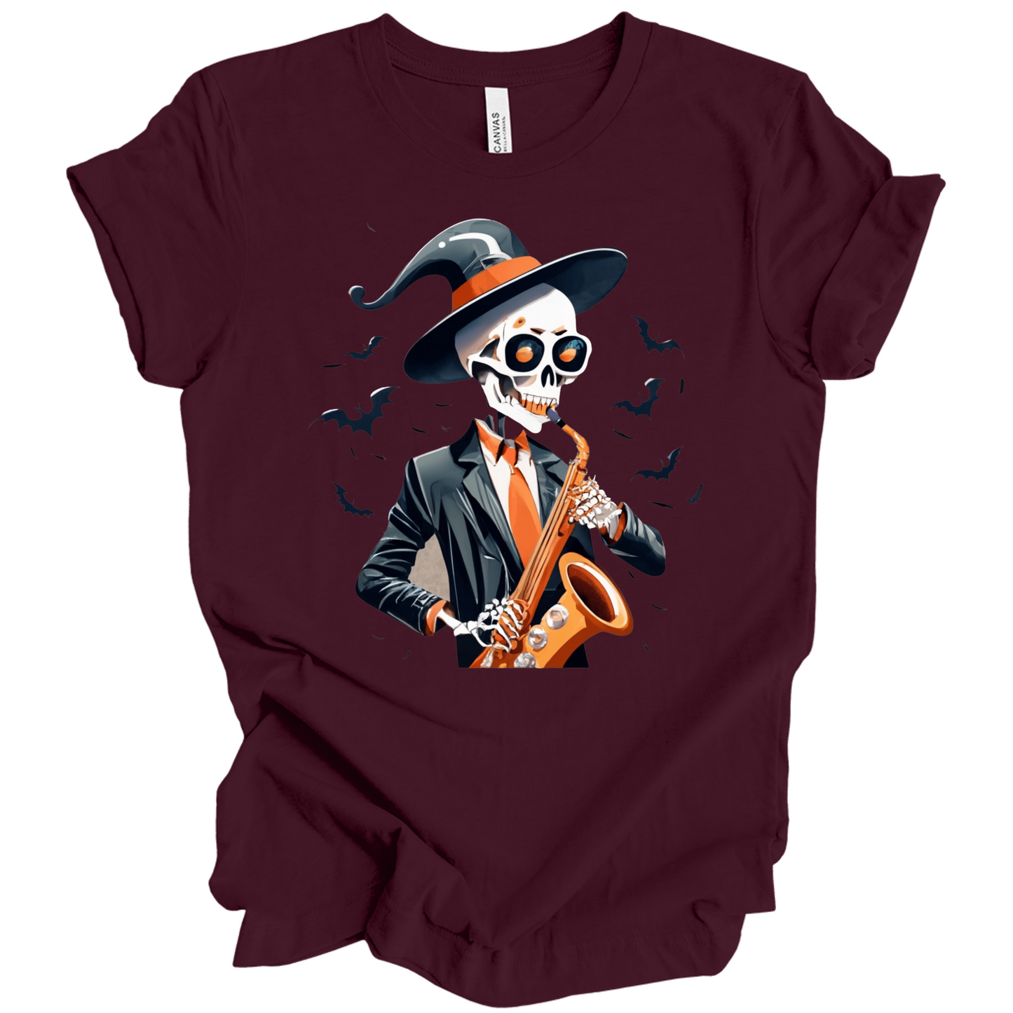 Maroon halloween t-shirt with a skeleton playing a saxophone and wearing a witch hat, surrounded by bats.
