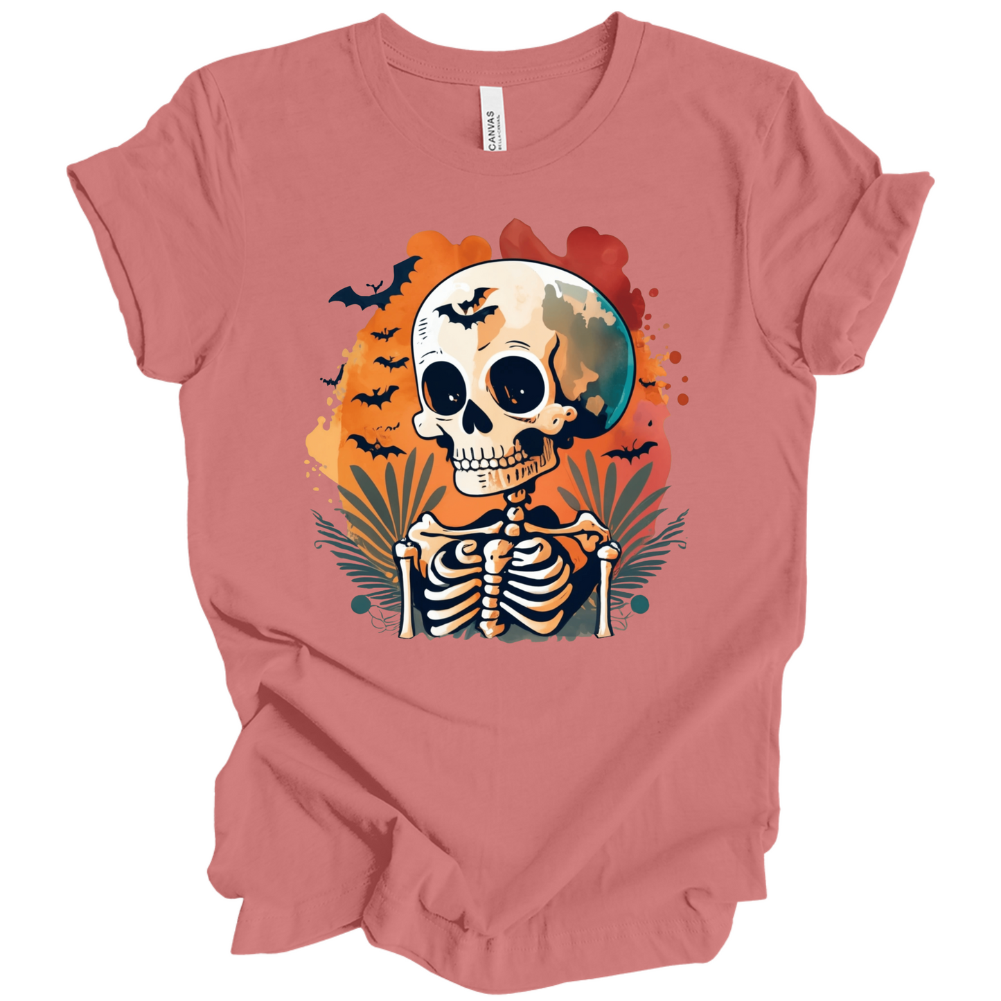 Pink t-shirt with a Halloween-themed design featuring a skeleton and skull surrounded with bats.