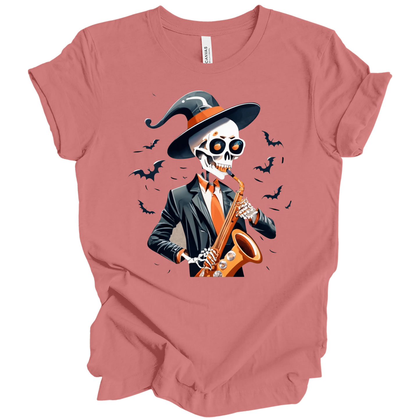 Pink halloween t-shirt with a skeleton playing a saxophone and wearing a witch hat, surrounded by bats.