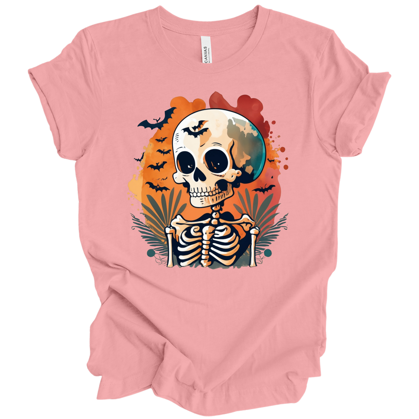 Pink t-shirt with a Halloween-themed design featuring a skeleton and skull surrounded with bats.