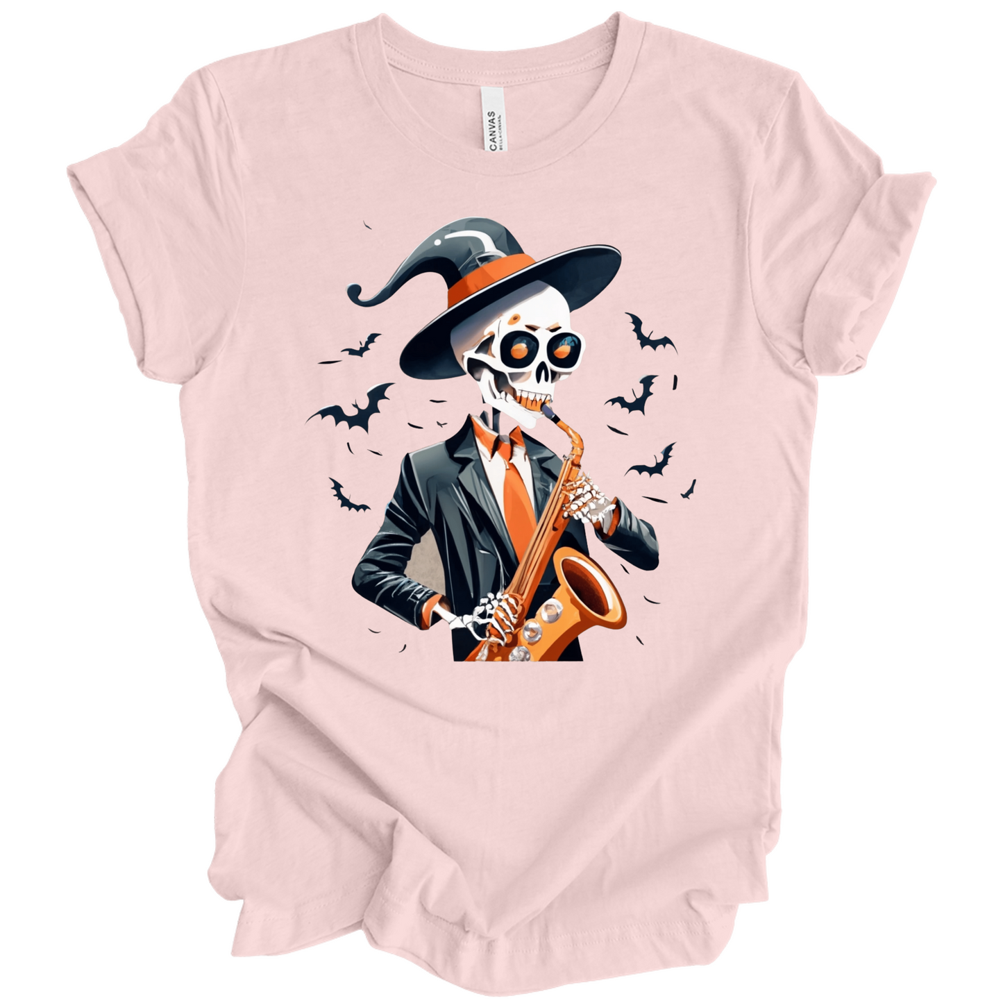 Pink halloween t-shirt with a skeleton playing a saxophone and wearing a witch hat, surrounded by bats.