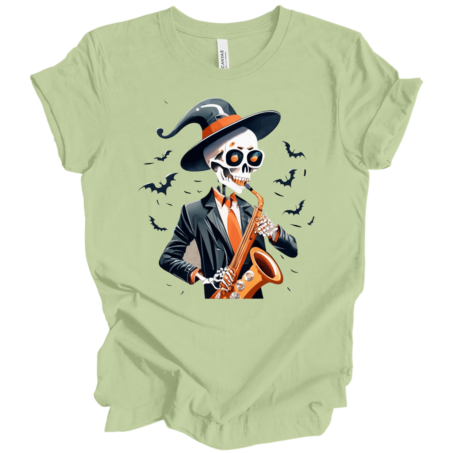 Light green halloween t-shirt with a skeleton playing a saxophone and wearing a witch hat, surrounded by bats.