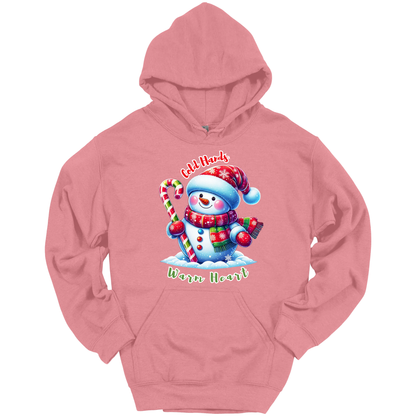 Pink Christmas hoodie with a snowman graphic with a text "Cold Hands Warm Hearts"
