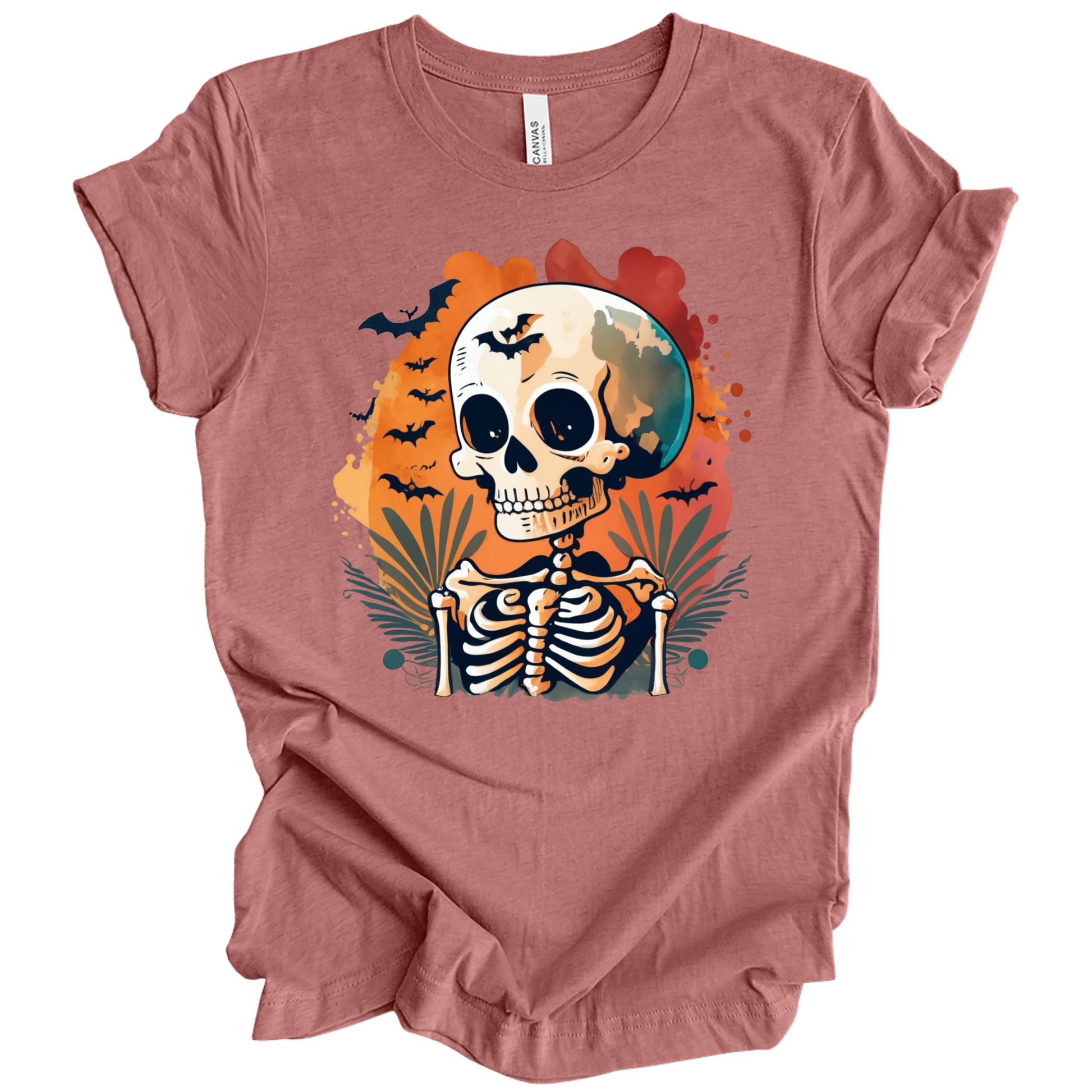 Pink t-shirt with a Halloween-themed design featuring a skeleton and skull surrounded with bats.
