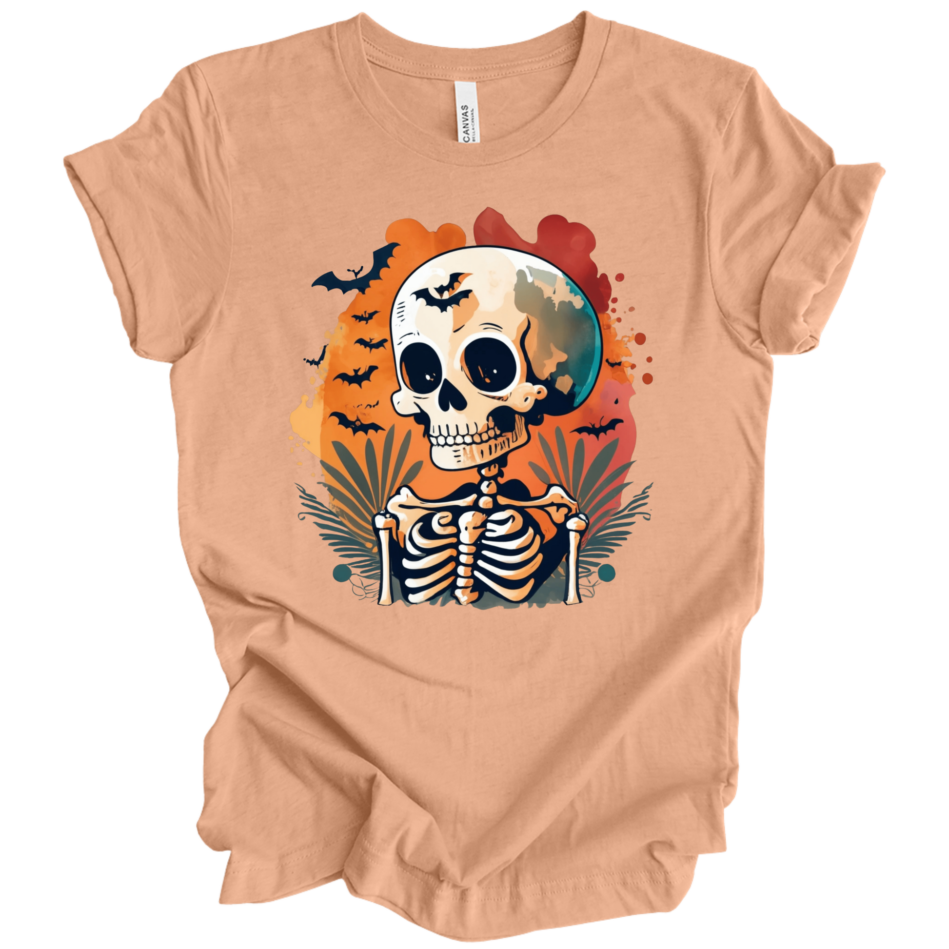 Peach t-shirt with a Halloween-themed design featuring a skeleton and skull surrounded with bats.