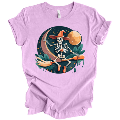 Purple halloween t-shirt with a skeleton on a broomstick wearing a witch hat in the night time.