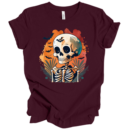 Maroon t-shirt with a Halloween-themed design featuring a skeleton and skull surrounded with bats.