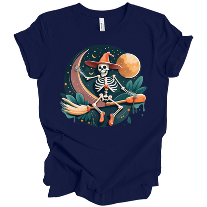 Navy blue halloween t-shirt with a skeleton on a broomstick wearing a witch hat in the night time.
