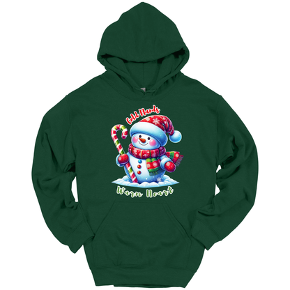 Green Christmas hoodie with a snowman graphic with a text "Cold Hands Warm Hearts"