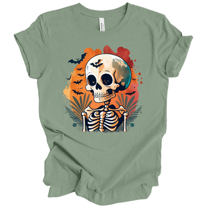 Green t-shirt with a Halloween-themed design featuring a skeleton and skull surrounded with bats.