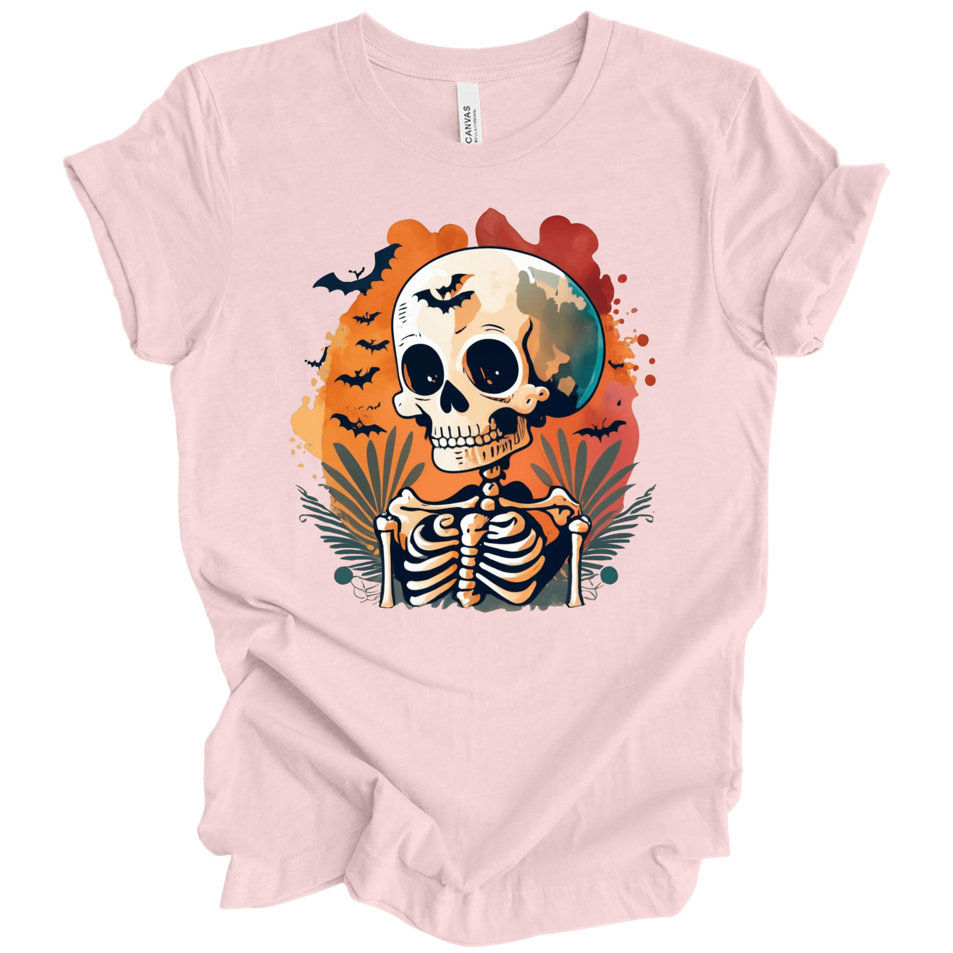 Pink t-shirt with a Halloween-themed design featuring a skeleton and skull surrounded with bats.