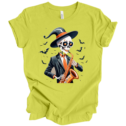 Green halloween t-shirt with a skeleton playing a saxophone and wearing a witch hat, surrounded by bats.