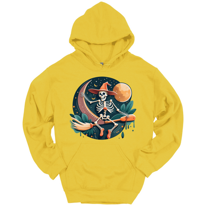 Yellow halloween hoodie with a skeleton on a broomstick wearing a witch hat in the night time.