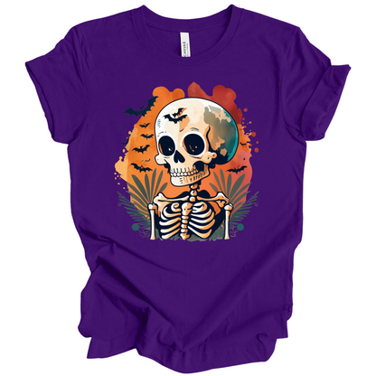 Purple t-shirt with a Halloween-themed design featuring a skeleton and skull surrounded with bats.